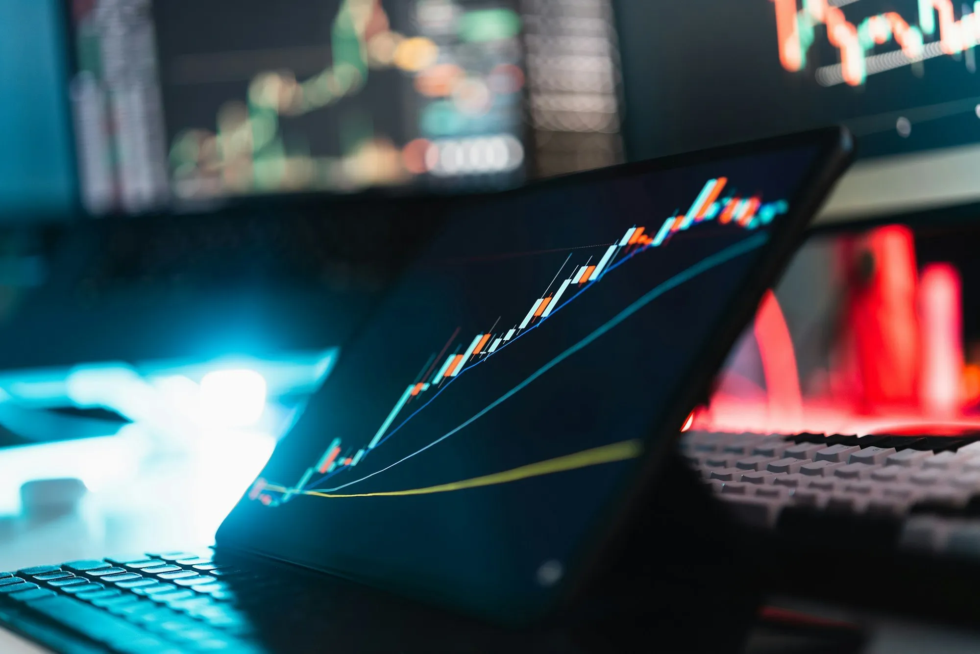 A tablet showing a rising chart on a desk